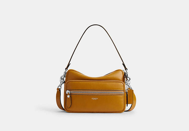 Front view of the cow leather Dakota crossbody bag showing a front zip pocket, detachable strap, and top handle.
