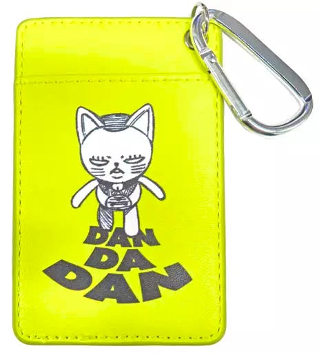 Front view of a neon yellow PVC leather card case showing a printed cat character, the text "DAN DA DAN", and a silver carabiner attached.