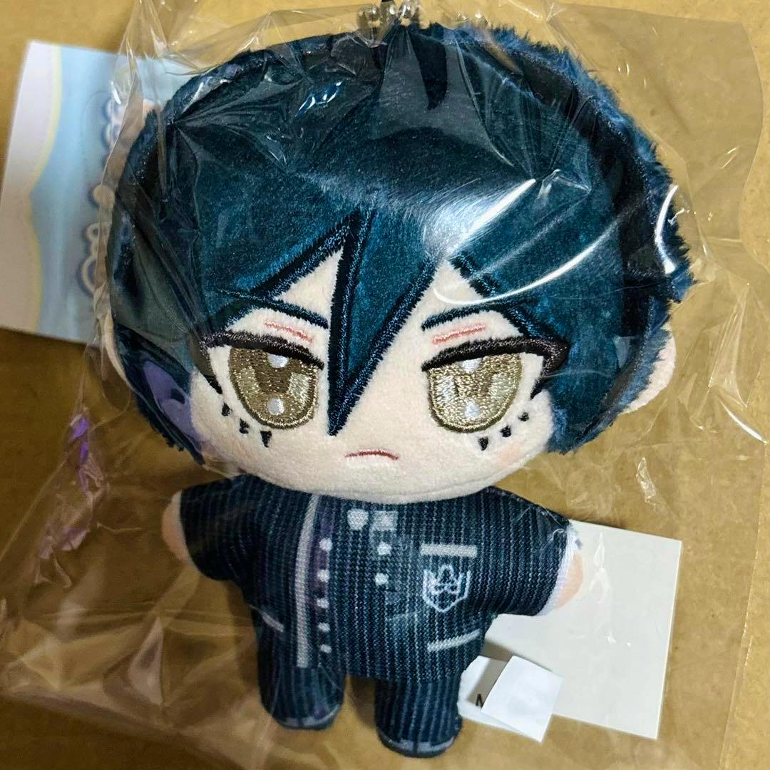 Front view of the Saihara Shuichi plush mascot keychain in its plastic bag, showing embroidered face and striped uniform.