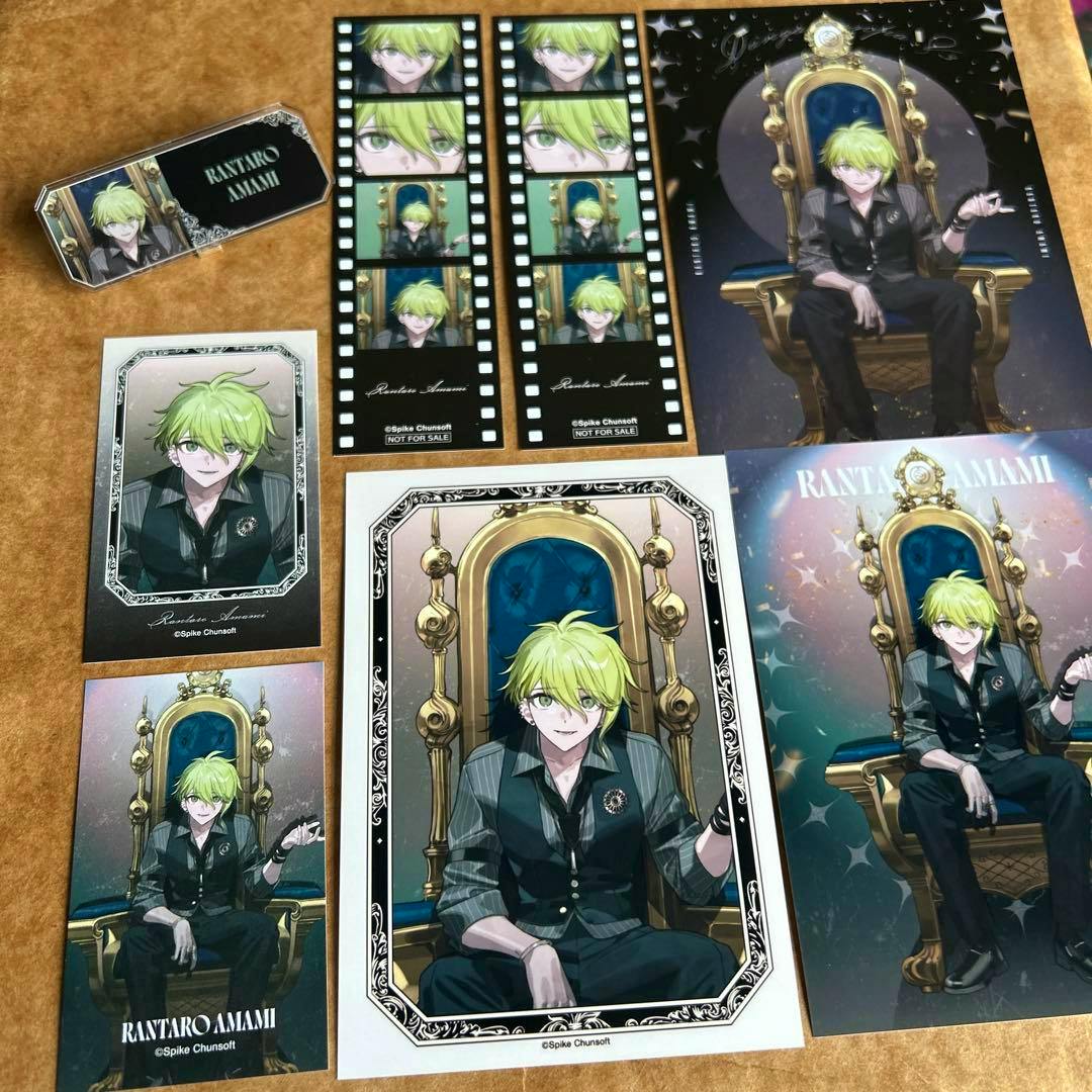 Photo showing multiple Rantaro Amami illustration cards and a matching nameplate arranged on a surface.