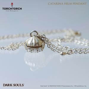 Close-up of a Catalina Helm pendant necklace in non-precious metal shown on its chain on a reflective surface.
