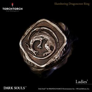 Close-up photo of the silver Slumbering Dragoncrest Ring (Dark Souls × TORCH TORCH) on a black background.
