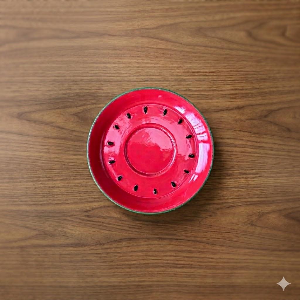 Top-down photo of a red ceramic mosquito coil tray placed on a wooden surface.