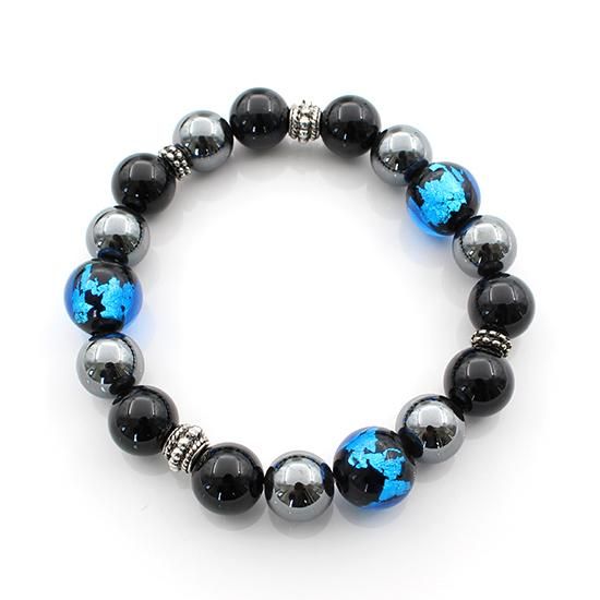Stretch bracelet composed of deep-sea blue lampwork beads, black onyx beads, hematite beads, and metal spacer accents.