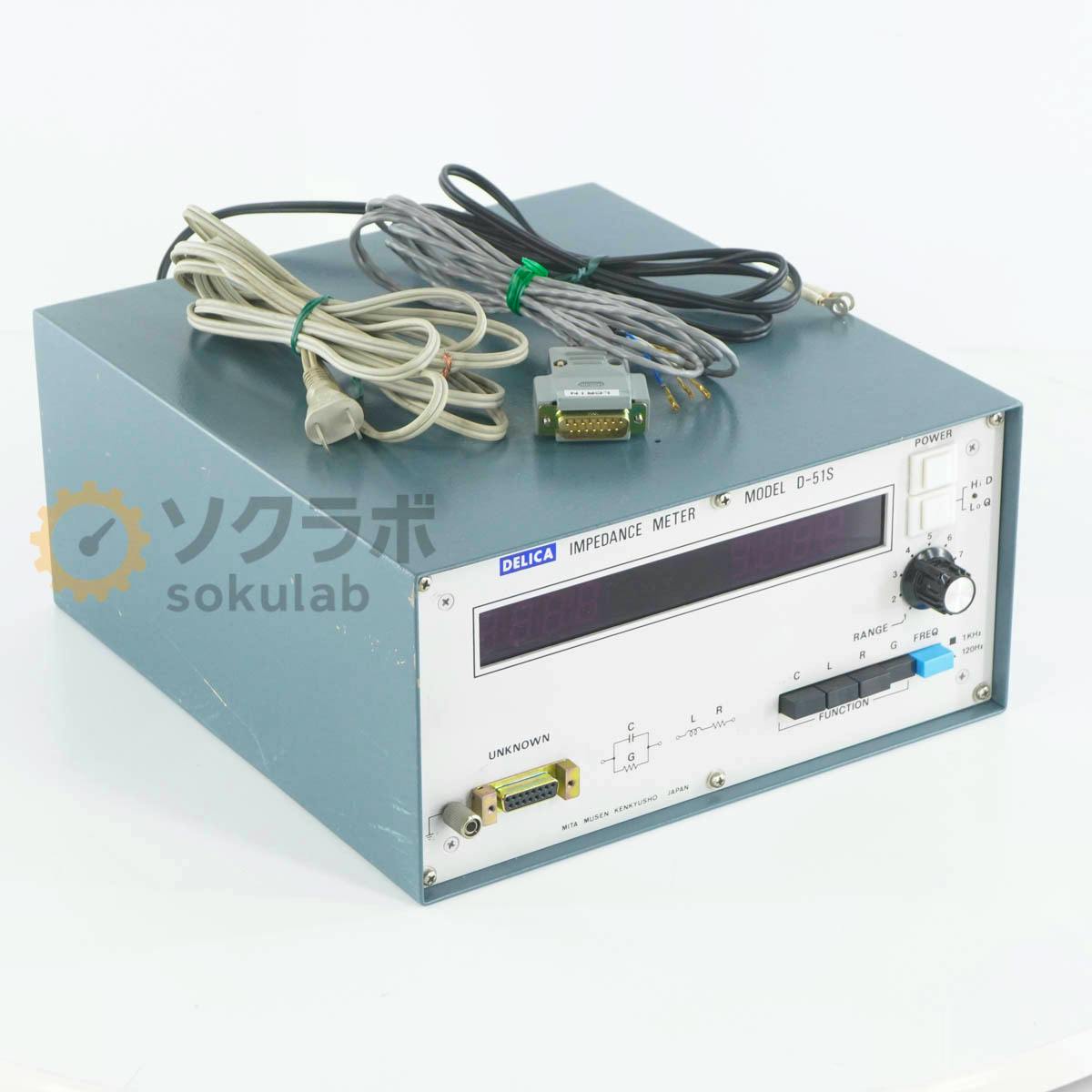 Front and top view of a Delica Model D-51S impedance meter with bundled cables placed on top.