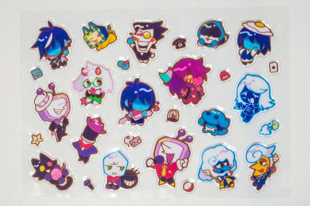 Sheet of Deltarune チャプター3 ぷっくりシール (puffy stickers) showing multiple small chibi character stickers on white backing.