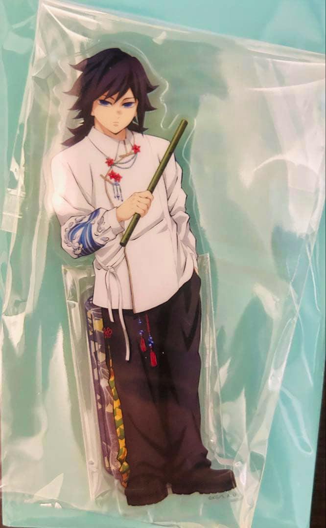 Packaged acrylic stand of 冨岡義勇 (Giyu Tomioka) from Demon Slayer shown full-body against a teal background.