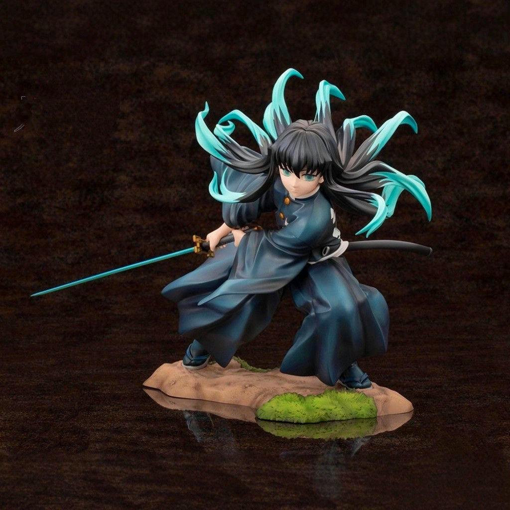 Plastic figure of Tokito Muichiro from Demon Slayer in a battle pose holding a sword on a rocky base.