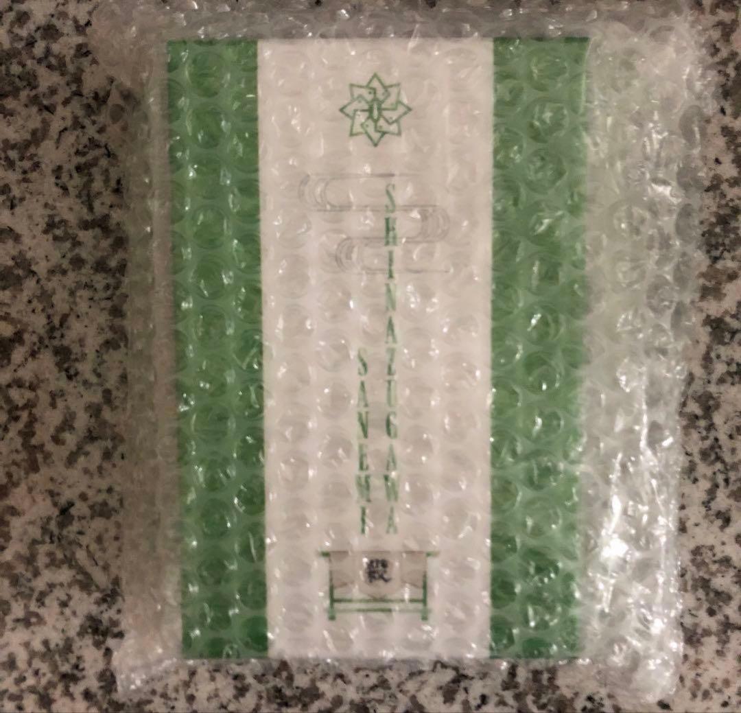 Front of the ONKYO Demon Slayer (Shinazugawa Sanemi) wireless earphones box wrapped in bubble wrap, showing a green and white design.