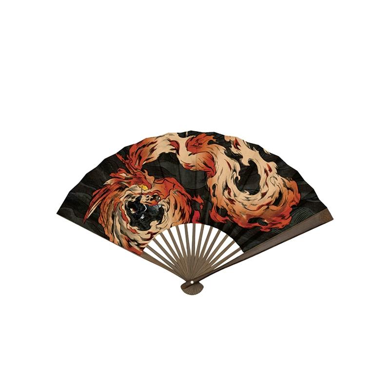 Paper folding fan with wooden ribs and a black background printed with swirling red-orange flame artwork from Kimetsu no Yaiba (Tanjiro Kamado).