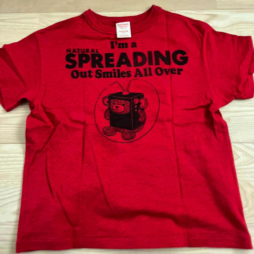 Red Denim Dungaree T-shirt laid flat showing a black printed slogan and a bear-in-a-box graphic.