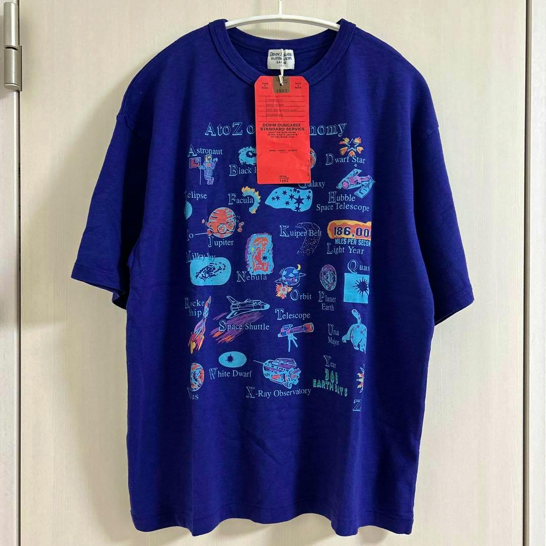 Front view of the short-sleeve T-shirt showing an astronomy-themed print and a red hang tag on a hanger.