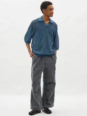 Model wearing the denim super wide cargo pants in grey, shown full-length with visible side cargo pockets.
