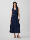 Front view of a model wearing the denim V-neck maxi dress.