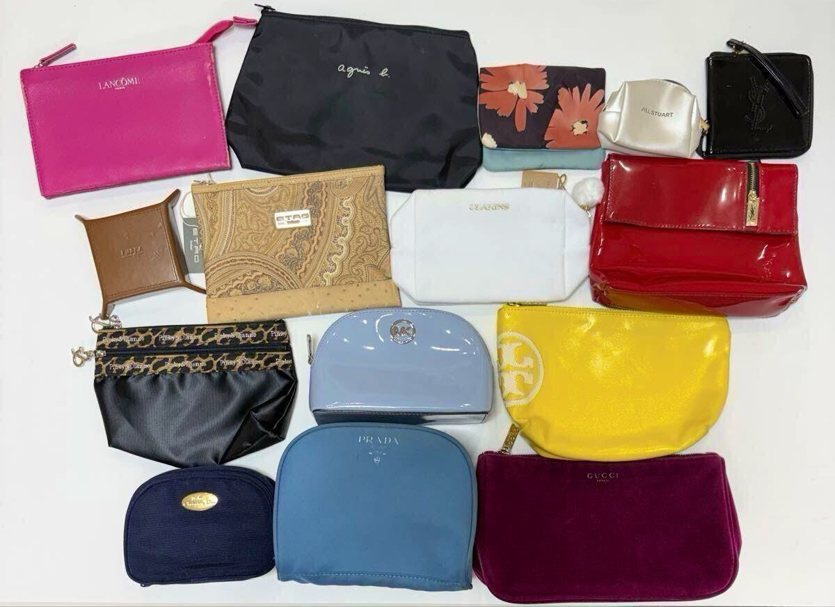 Fifteen assorted brand pouches and small bags arranged on a white background, showing various colors and logos (Prada, Gucci, etc.).