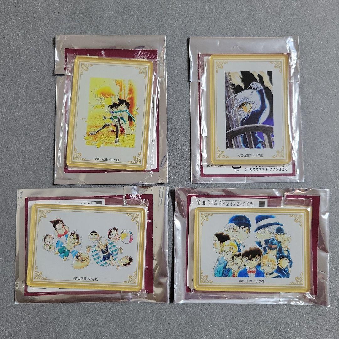 Four packaged Detective Conan acrylic fridge magnets arranged on a gray surface.