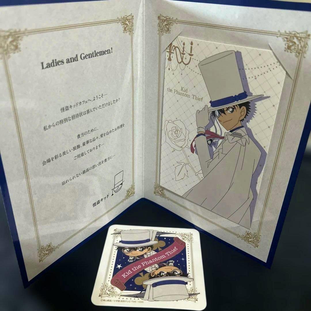 Opened Kid the Phantom Thief café invitation displaying an illustration of Kaito Kid with the accompanying coaster placed in front.