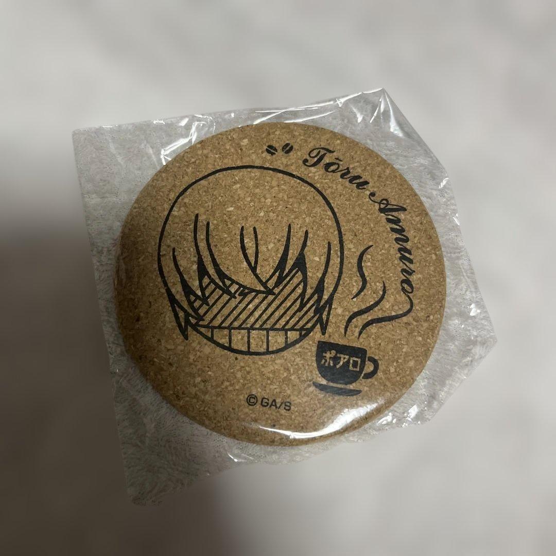 Front of a round cork coaster showing a printed Tooru Amuro face and a small coffee cup, pictured in plastic wrap.