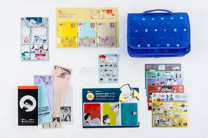 Flat lay of Detective Conan memo set items: three numbered memo pads, various character sticky notes and sticker sheets, and a blue pouch.