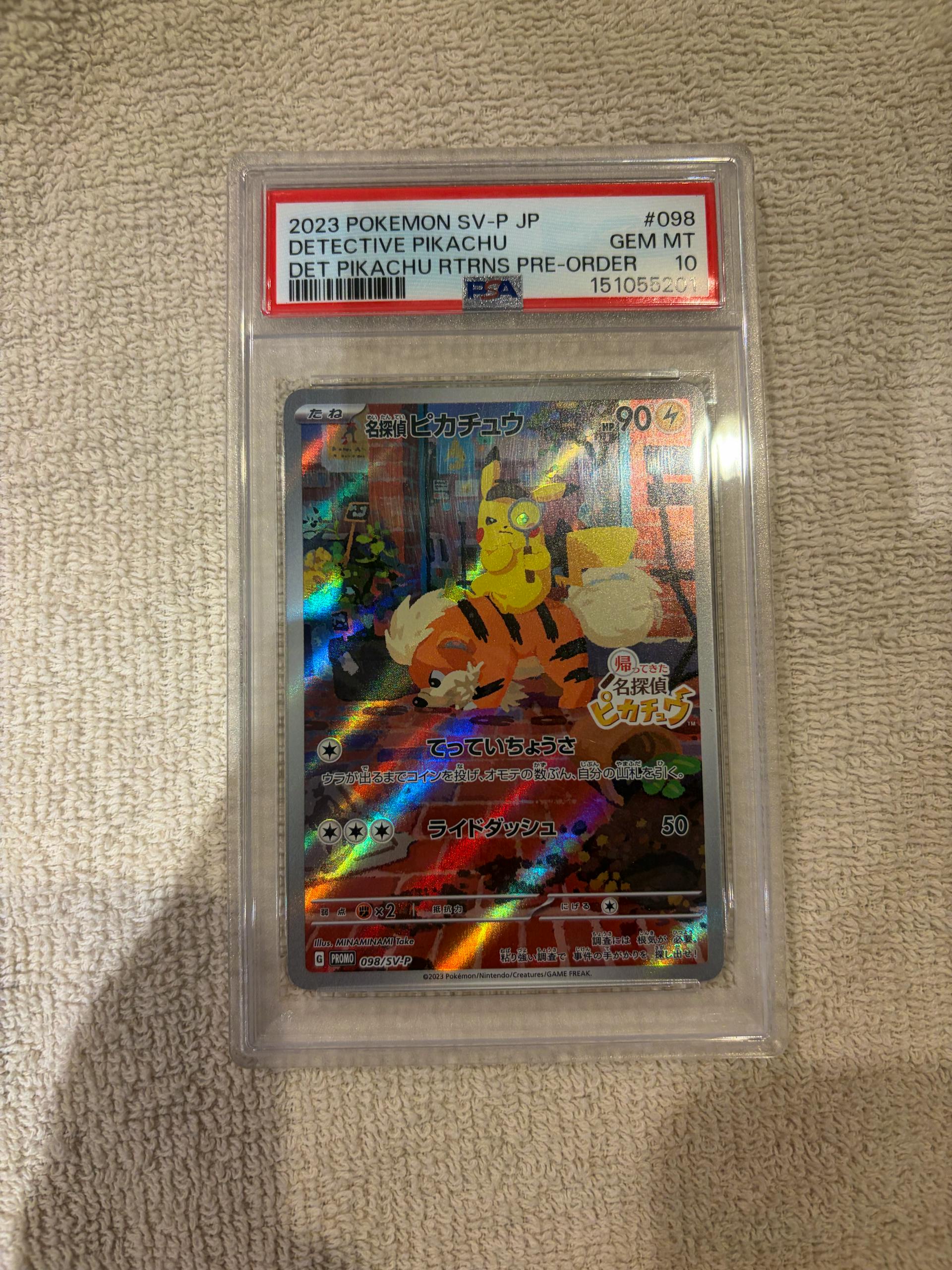 Front of a PSA-graded Detective Pikachu promo trading card (SV-P 098) in a clear plastic slab showing the card art and the PSA label at top.