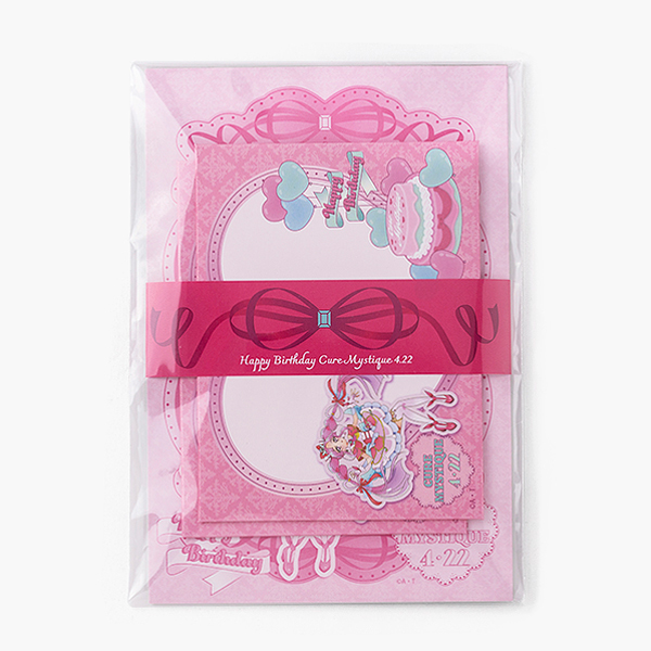 Packaged pink Cure Mystic birthday letter set with decorated stationery visible through clear plastic.