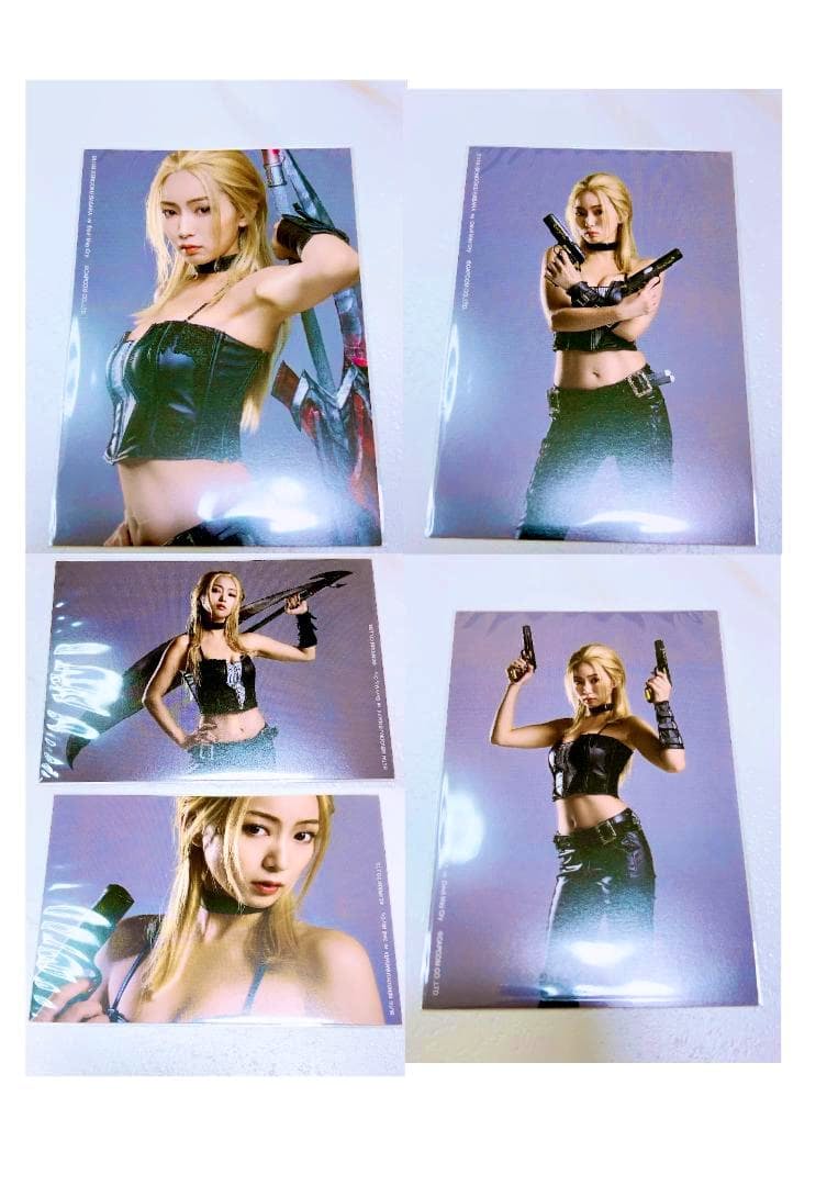 Multiple glossy stage Devil May Cry photographs of Trish (階戸瑠李) laid out on a flat surface.