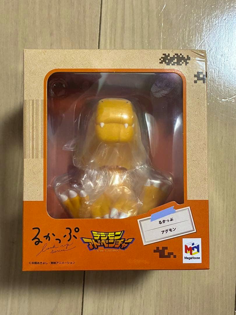 Boxed Digimon Adventure MegaHouse Agumon るかっぷ figure visible through the front window of its packaging.