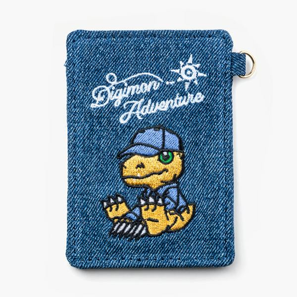 Front-facing denim card/pass case featuring an embroidered Agumon and "Digimon Adventure" text with a metal ring on the side.