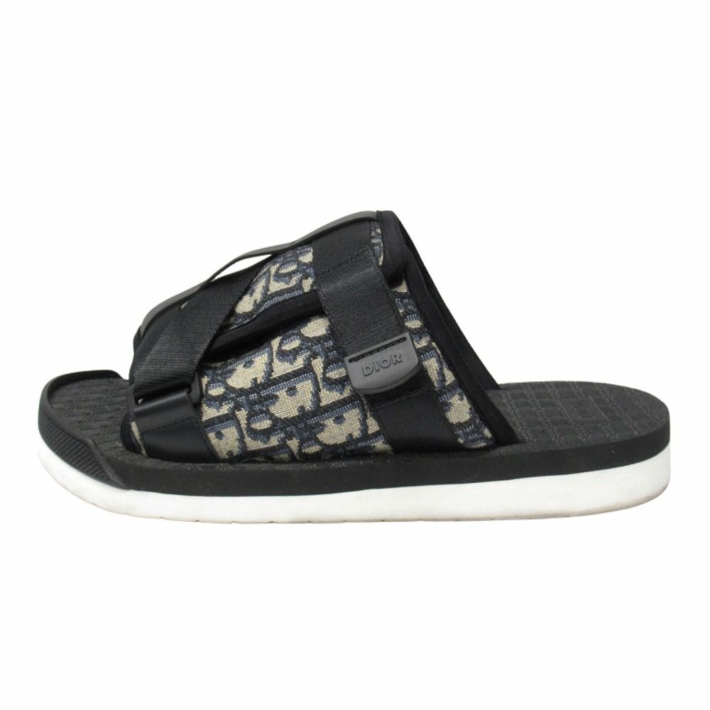 Side view of a Dior Alpha slide sandal with oblique jacquard strap and white sole.