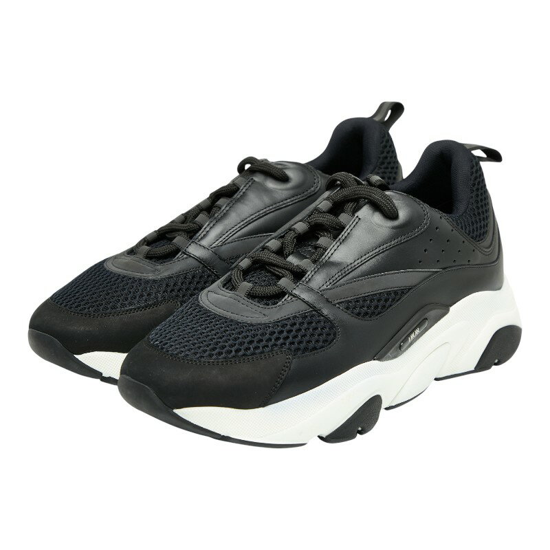 Front-side view of a pair of black and white Dior B22 men's sneakers with fabric and leather upper.