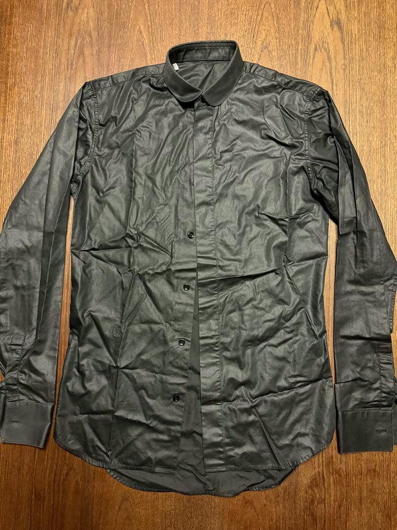Black Dior Homme round-collar long-sleeve button-up shirt laid flat on a wooden surface.