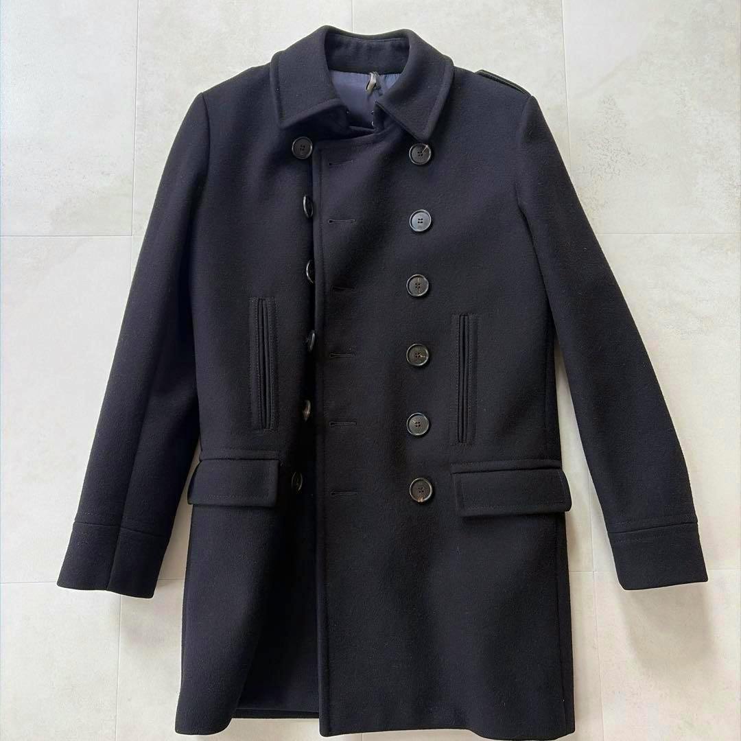 Front view of a men's wool coat laid flat, showing double-breasted buttons and front pockets.