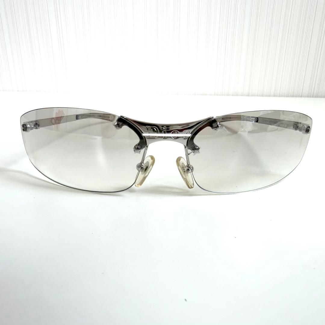 Front-facing silver Dior sunglasses with gray gradient rimless lenses on a white background.