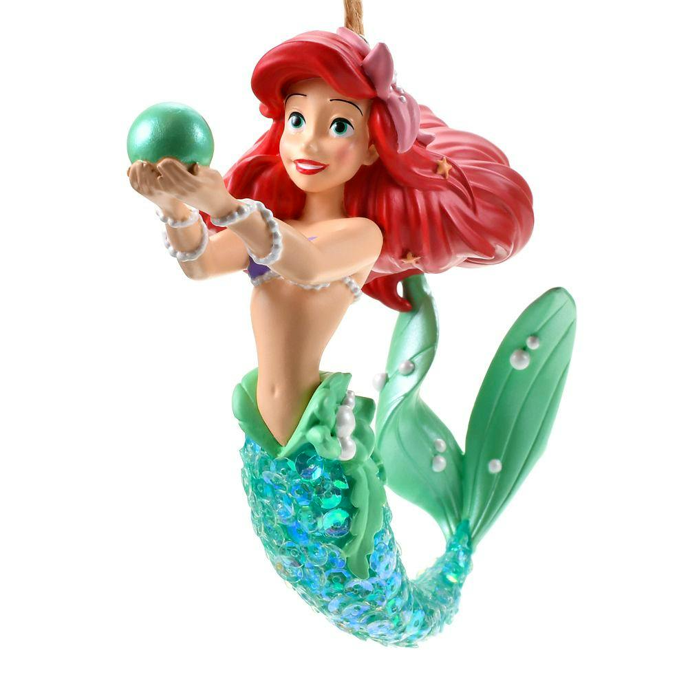Ariel Disney Christmas ornament showing the mermaid with red hair, a green sequined tail, and holding a green ball.