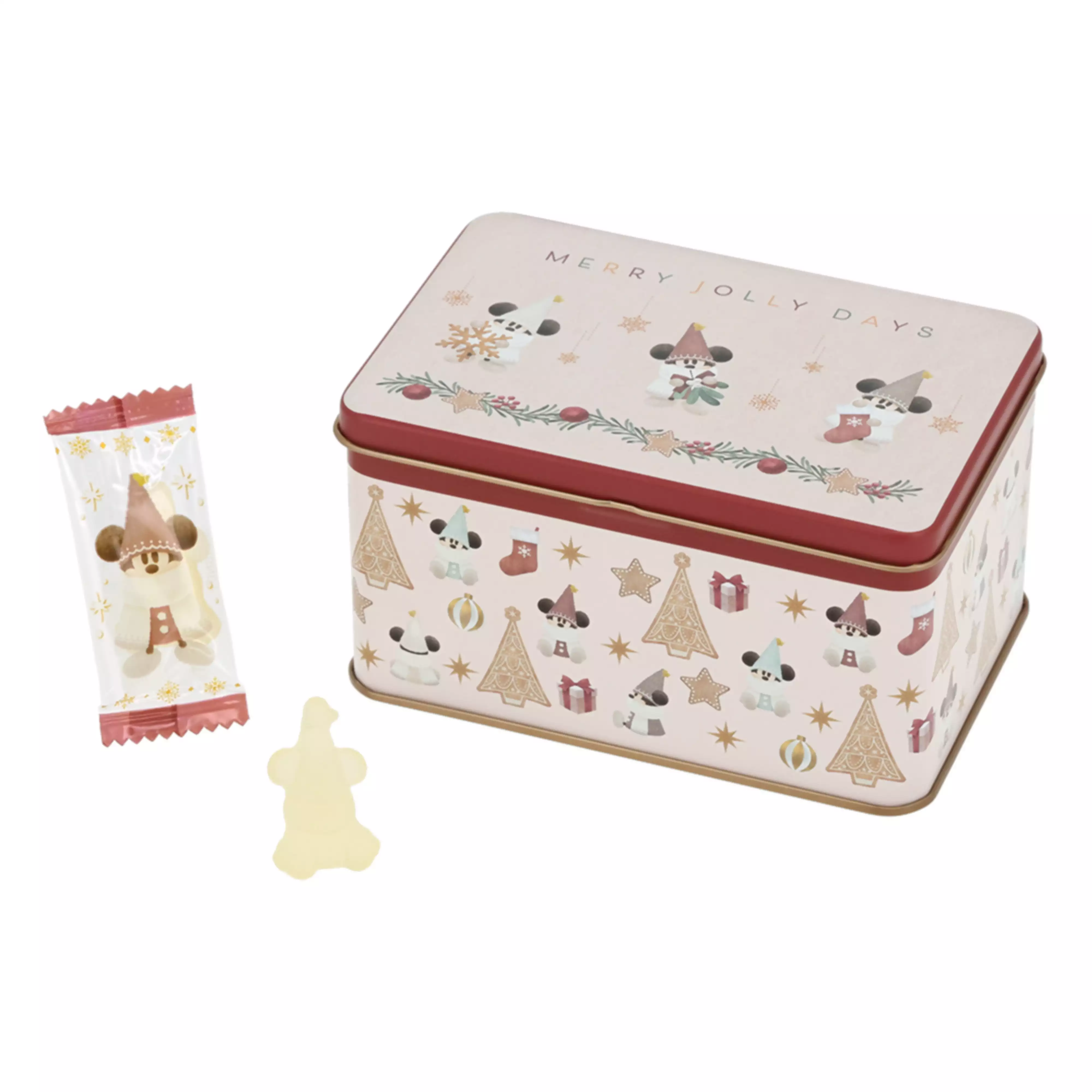 A Disney Christmas decorative metal tin with holiday illustrations, a wrapped gummy candy, and an unwrapped gummy displayed next to it.