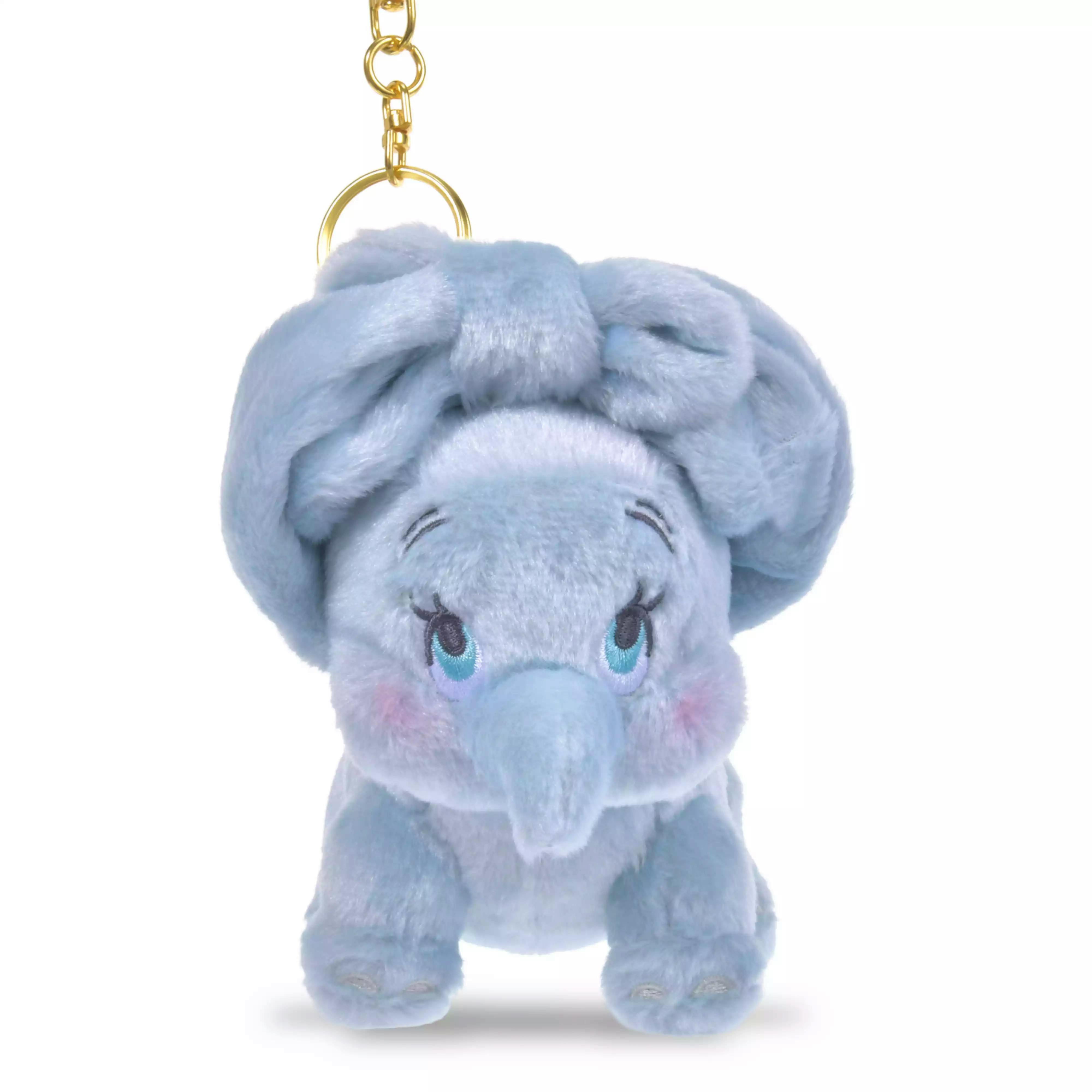 Front view of a light-blue Dumbo plush keychain with embroidered eyes and a gold key ring on a white background.