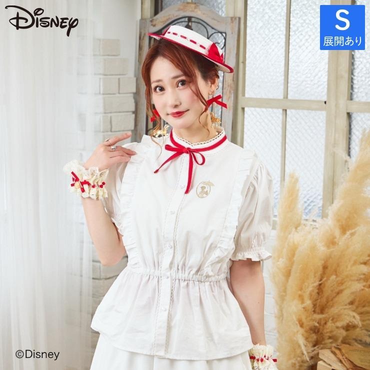 A woman modeling the listed women's cotton blouse with puff sleeves, ruffle trims, and a red neck ribbon.