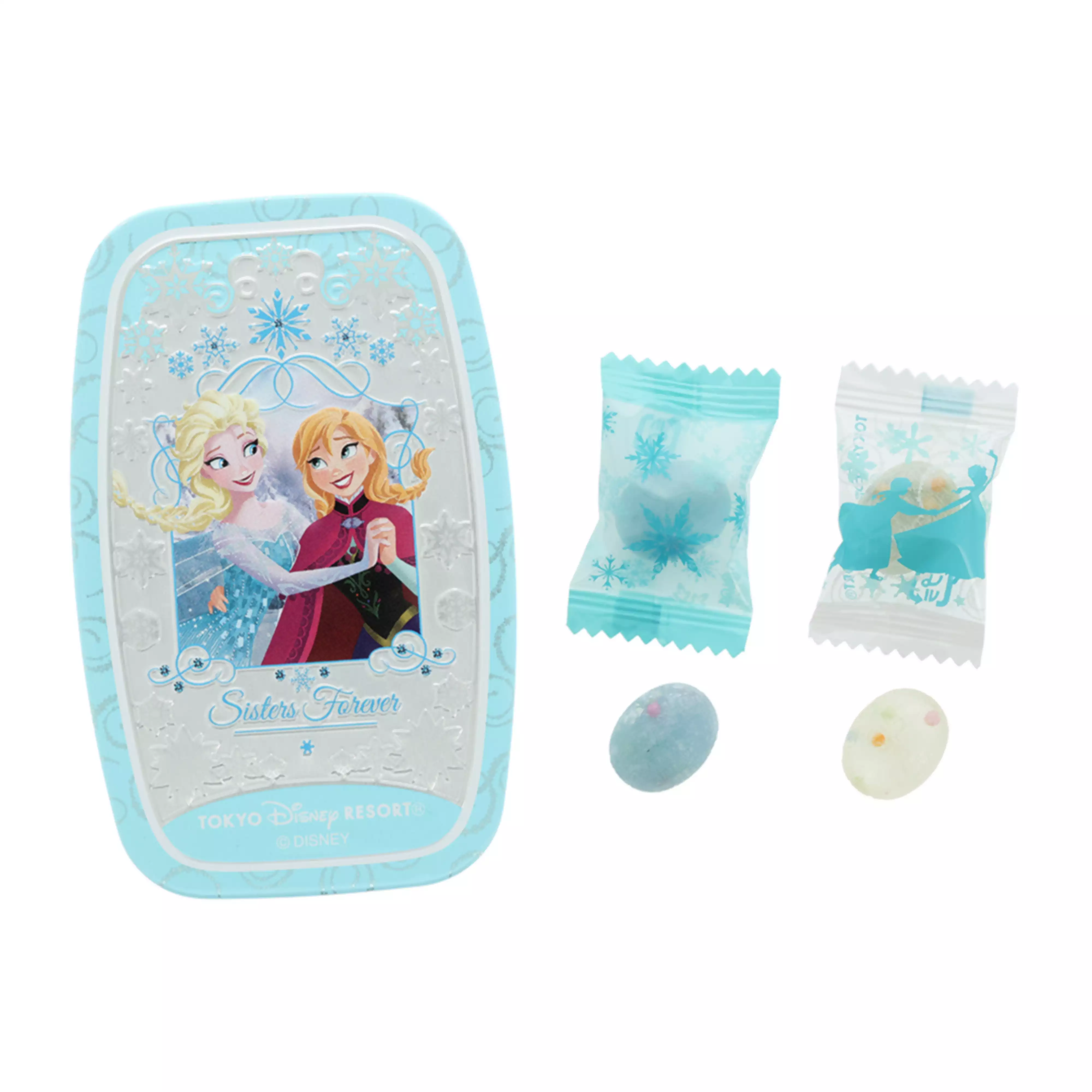 A light-blue candy tin decorated with Anna and Elsa shown alongside individually wrapped candies and two loose sugar candies.