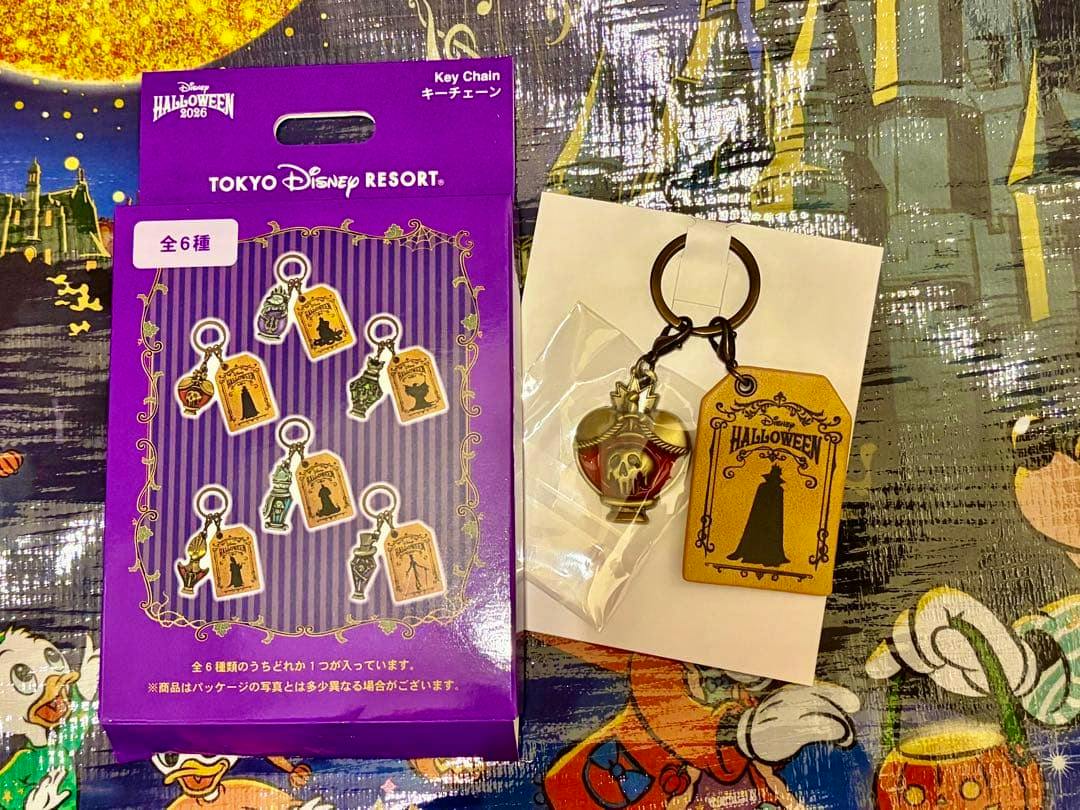 Photo of the Disney Halloween 2026 bag charm keychain and its purple Tokyo Disney Resort packaging, showing the charm and a decorative tag.