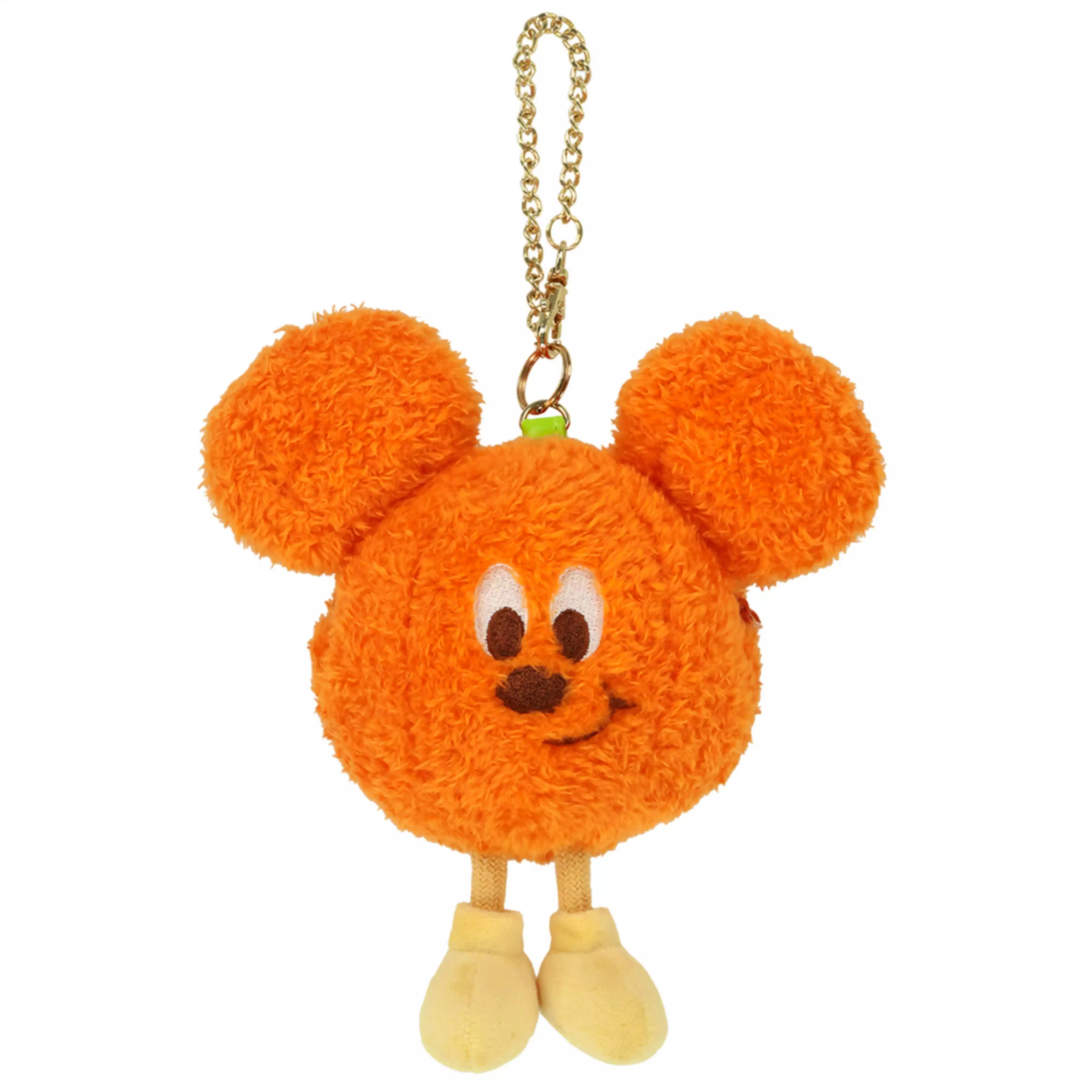 Orange Disney Halloween plush pouch keychain on a white background, showing round ears, embroidered face, yellow legs and a gold hanging chain.