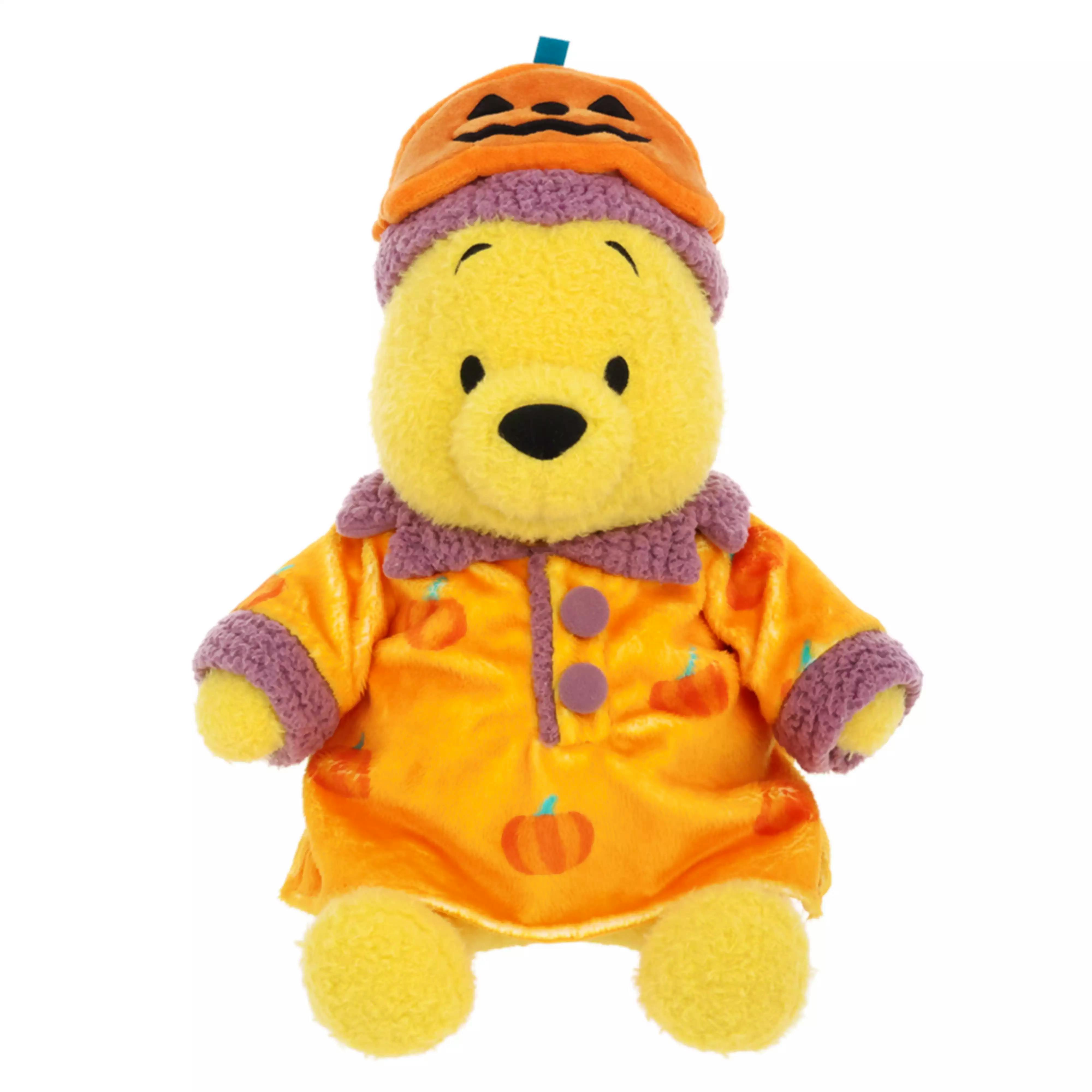 Front view of the Pooh plush toy wearing an orange Halloween pumpkin-themed costume.