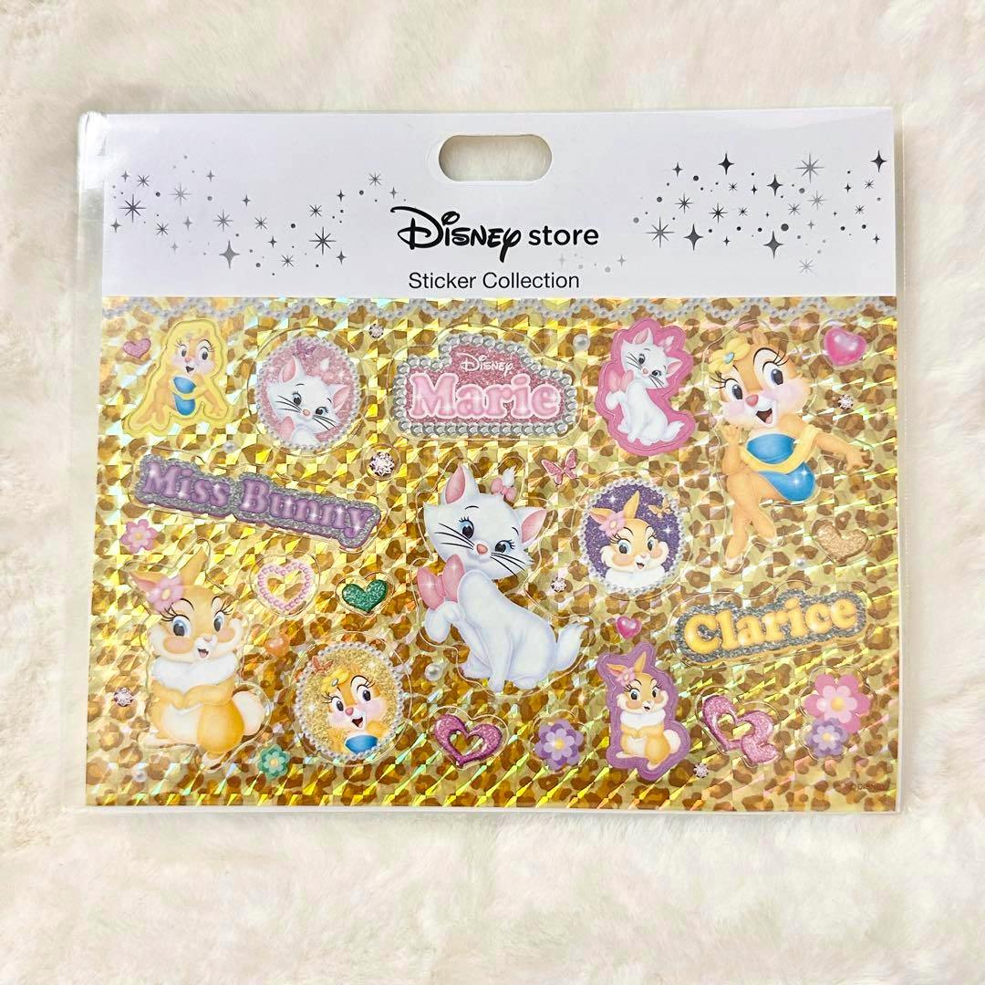 Packaged holographic Disney sticker sheet featuring Marie, Clarice, and Miss Bunny designs on a gold background.