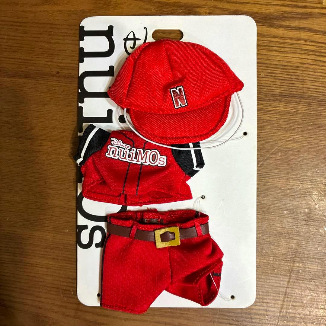 Red Disney nuiMOs baseball costume set with cap, jersey, and pants displayed on a backing card.