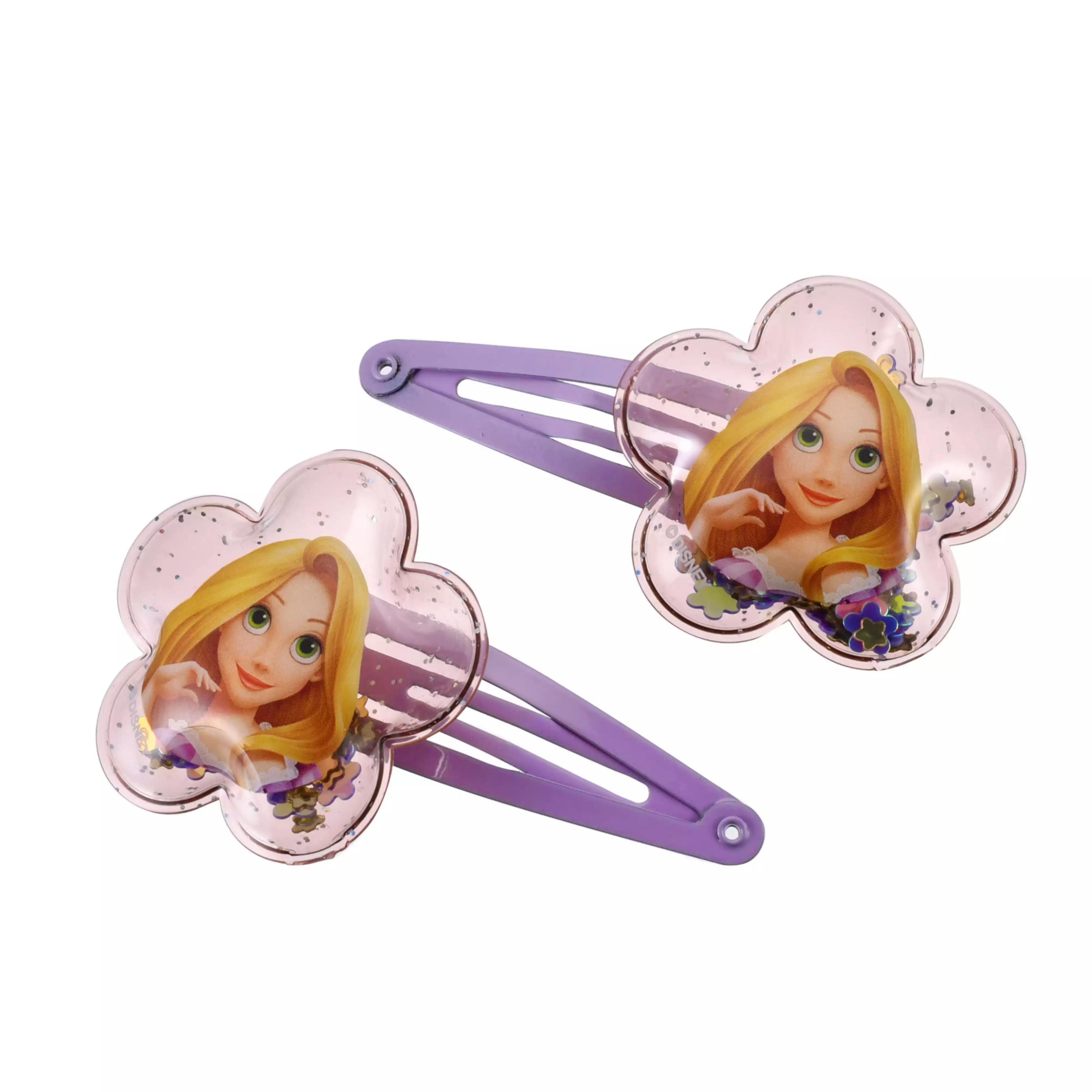 Close-up of purple kids hair clips featuring Rapunzel-themed flower-shaped glitter-filled decorations.