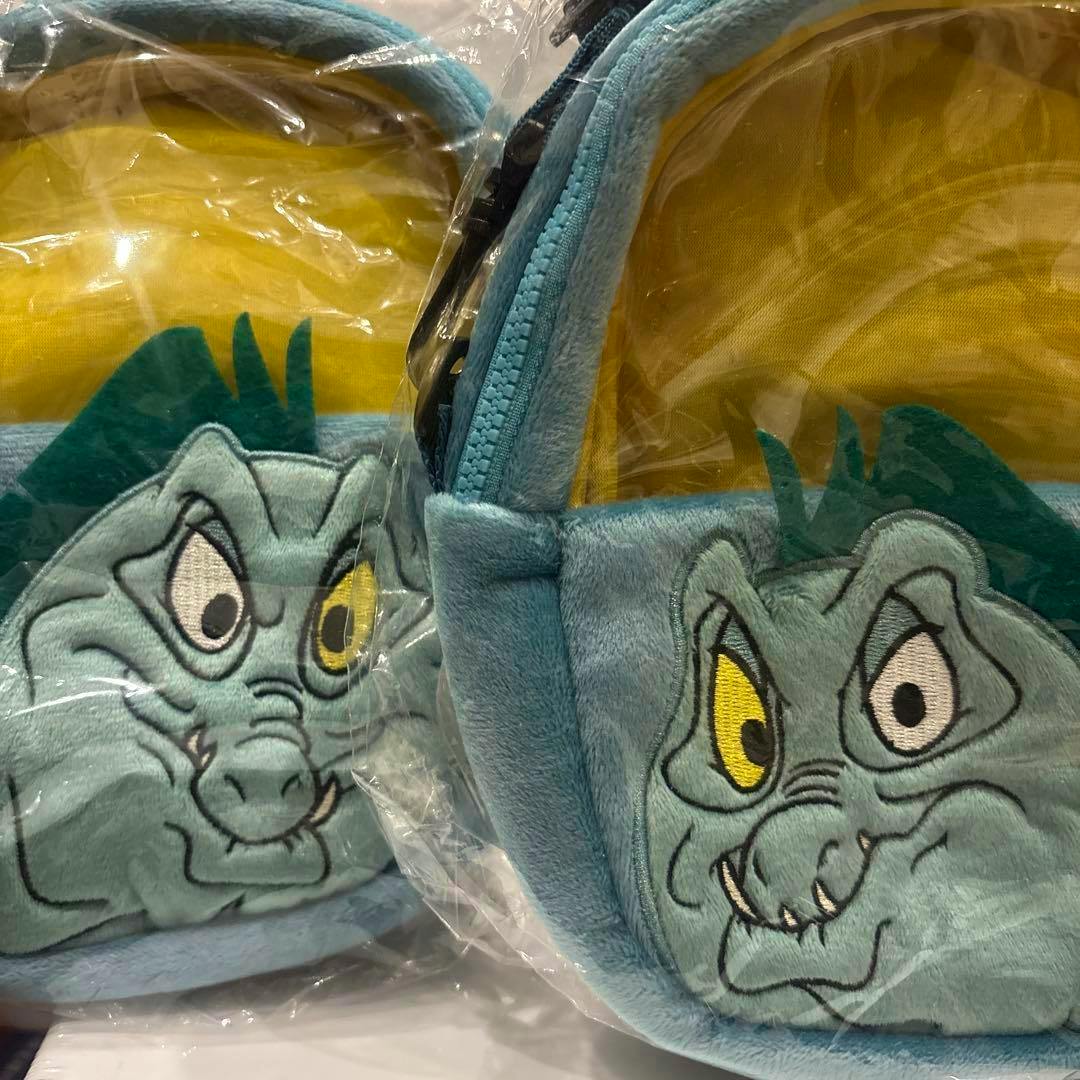 Two teal plush windowed pochettes featuring embroidered Flotsam and Jetsam faces, shown in plastic packaging.