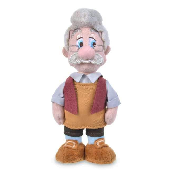 Front-facing plush of Geppetto from Pinocchio wearing glasses, a vest, and brown shoes on a white background.