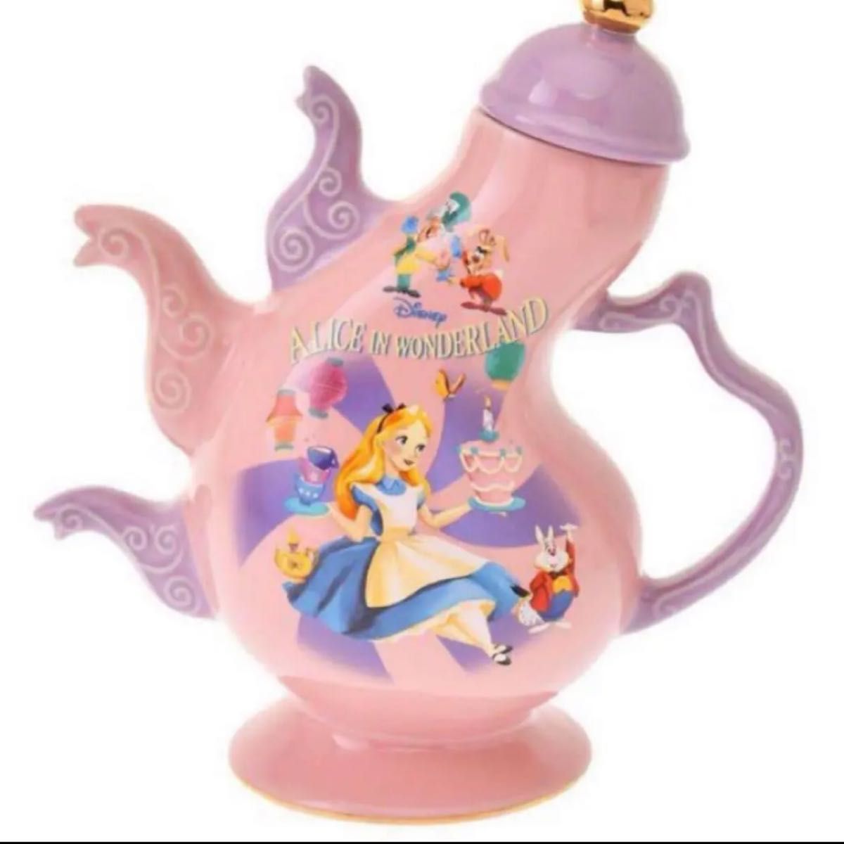 Pink ceramic Alice in Wonderland teapot showing Alice artwork, with a purple handle and lid and decorative spouts.