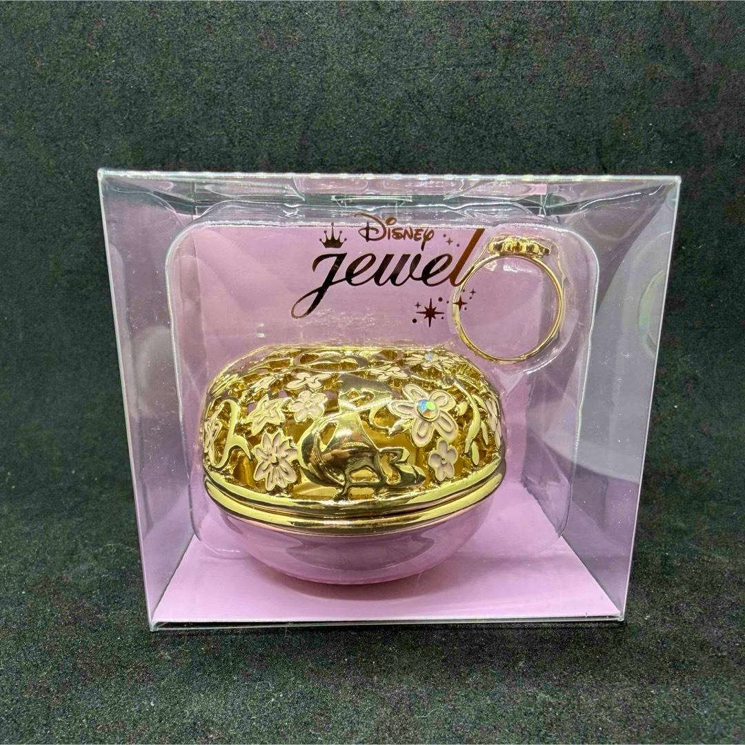 Unopened Disney Jewel boxed set showing a gold decorative ring case and a gold ring inside a clear plastic display with pink backing.