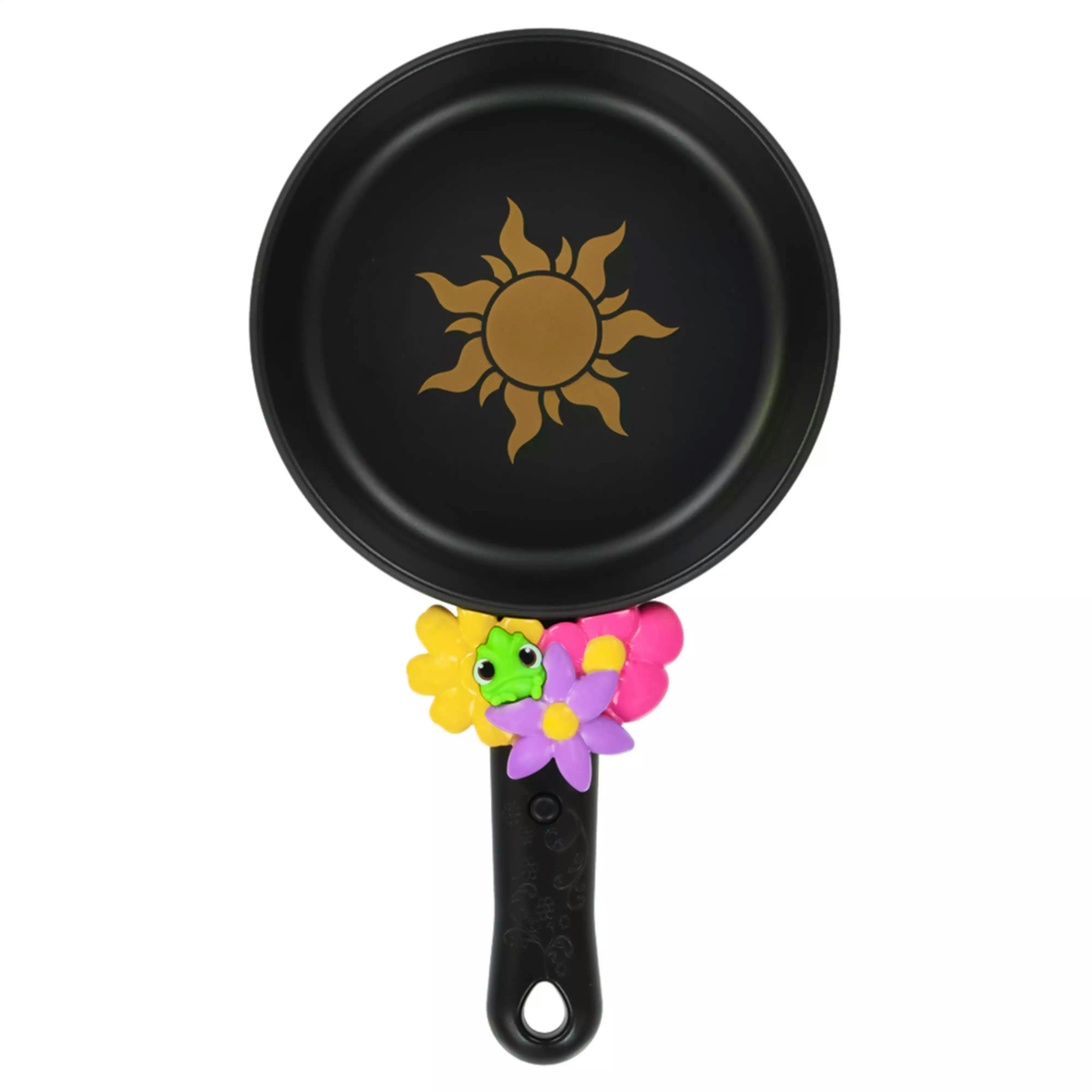Toy black plastic frying pan with a gold sun emblem and a handle decorated with colorful flowers and a small green chameleon, styled for Rapunzel.
