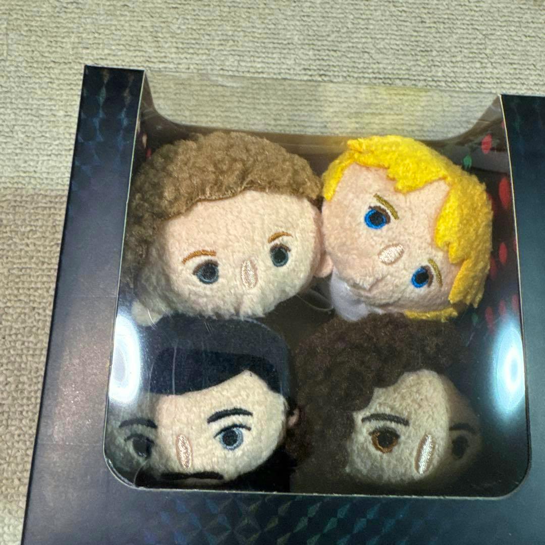 Four Tsum Tsum plush heads visible through a display box window.